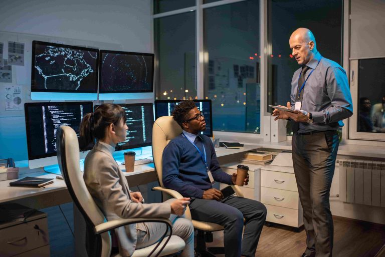 Two members of staff receiving cybersecurity training to identify phishing and other attacks, in order to protect their small business.