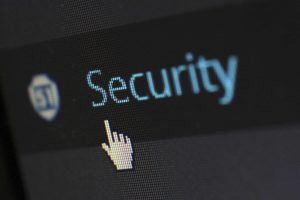 A mouse hovering over a cybersecurity report button. For small businesses, this is a vital tool for staff to flag potential phishing emails.